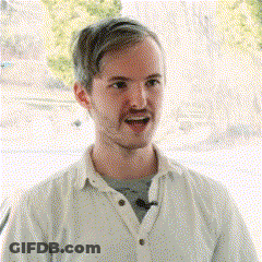 Man In White Shirt Smiling With Microphone GIF