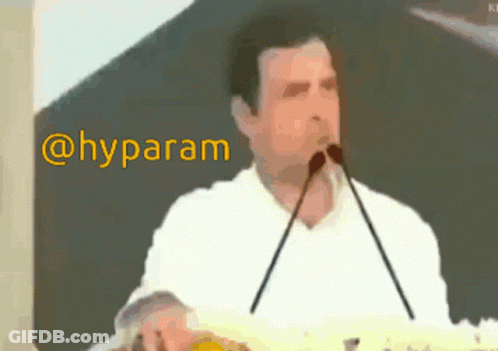 Man In White Shirt Speaking Into Microphone Hyparam GIF