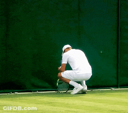 Man In White Shirt Squatting On Tennis Court GIF