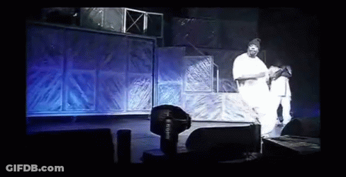 Man In White Shirt Standing At Microphone GIF