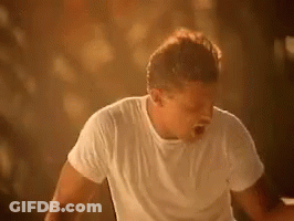Man In White Shirt Standing Before Crowd GIF