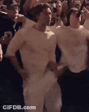 Man In White Shirt Standing Before Crowd GIF