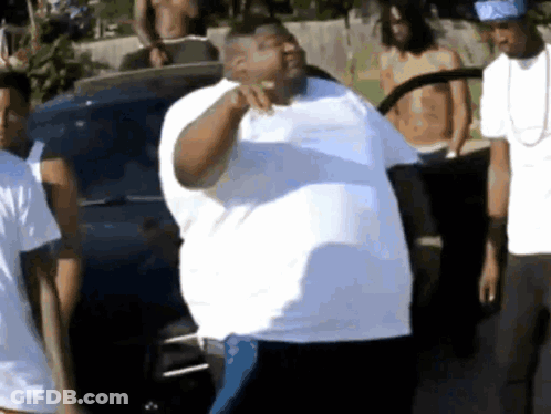 Man In White Shirt Standing Before Group GIF