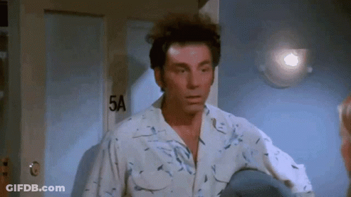 Man In White Shirt Standing By Door GIF