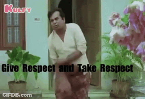 Man In White Shirt Standing By Door With Flower Pots GIF