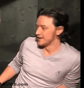 Man In White Shirt Standing In Dark Room GIF