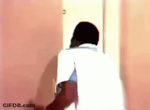 Man In White Shirt Standing In Doorway GIF