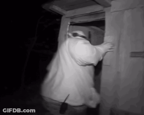 Man In White Shirt Standing In Doorway With Walkie Talkie GIF