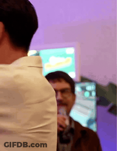 Man In White Shirt Standing In Front Of Coca Cola Screen GIF
