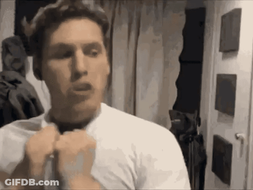 Man In White Shirt Standing In Front Of Door GIF