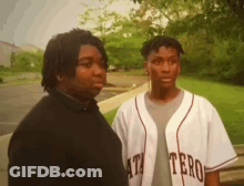 Man In White Shirt Standing In Front Of Door GIF