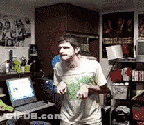Man In White Shirt Standing In Front Of Laptop GIF