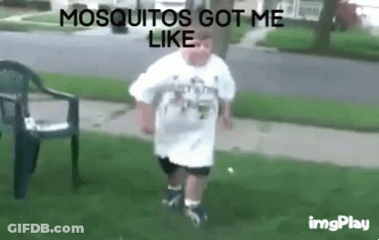 Man In White Shirt Standing In Grass Saying Mosquitos Got Me Like GIF