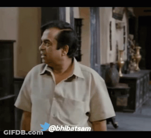 Man In White Shirt Standing In Hallway GIF