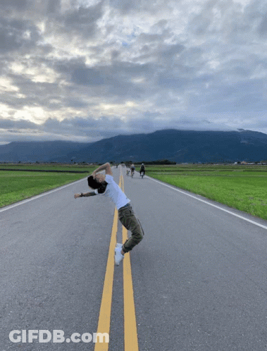 Man In White Shirt Standing On Road GIF