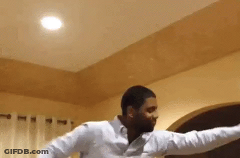 Man In White Shirt Standing With Arms Outstretched GIF