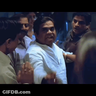 Man In White Shirt Surrounded By Men GIF