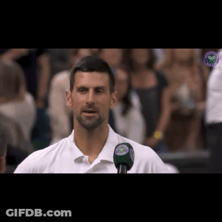Man In White Shirt Talking Into Microphone With Wimbledon Logo GIF