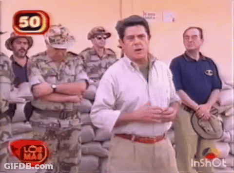 Man In White Shirt Talking To Soldiers GIF