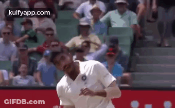 Man In White Shirt Throwing Ball In Front Of Crowd GIF