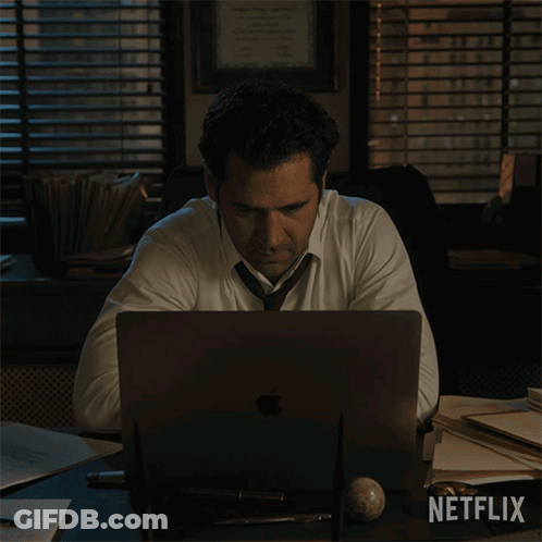 Man In White Shirt Tie At Desk Netflix Logo GIF