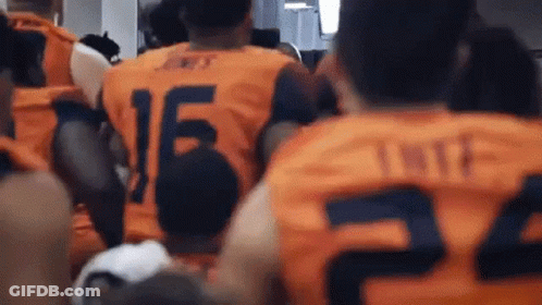 Man In White Shirt Walking On Football Field GIF
