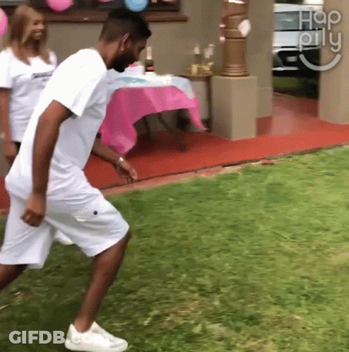 Man In White Shirt Walking On Lush Green Lawn GIF
