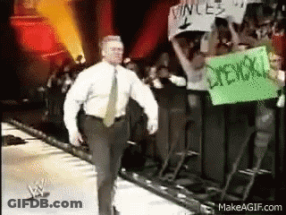 Man In White Shirt Walking On Stage With Vince Sign GIF