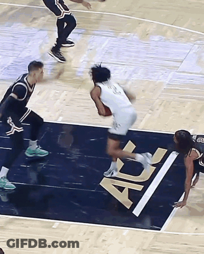 Man In White Shirt Walking Through Crowd GIF