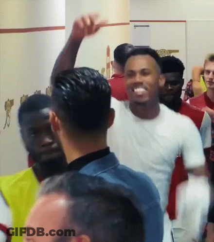 Man In White Shirt With Arm Raised GIF