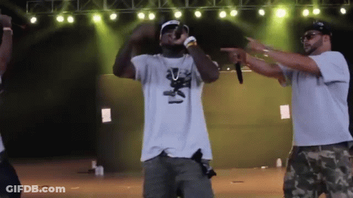 Man In White Shirt With Bear Singing Into Microphone GIF