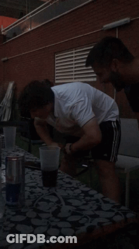 Man In White Shirt With Beer At Table GIF