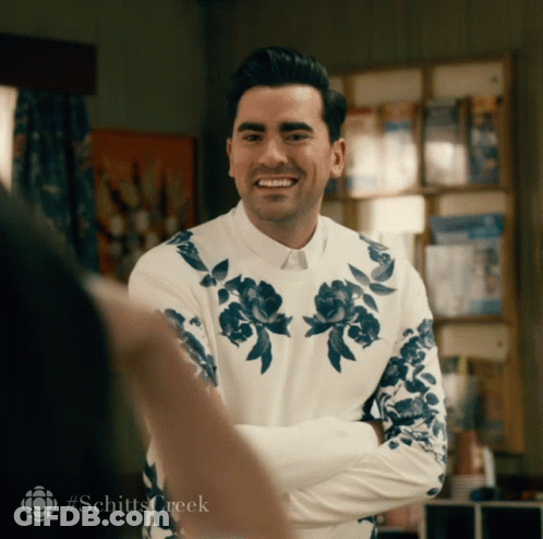 Man In White Shirt With Blue Flowers Smiling GIF