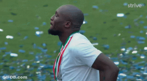Man In White Shirt With Confetti And Strive GIF