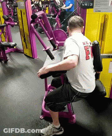 Man In White Shirt With F On Gym Machine GIF