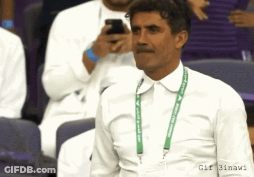 Man In White Shirt With Green Lanyard Saying Saudi Arabia GIF