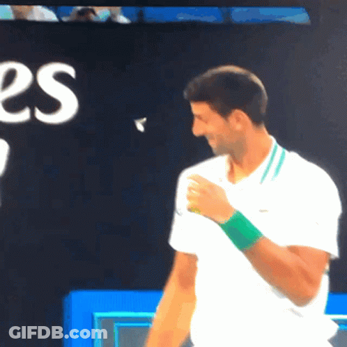 Man In White Shirt With Green Wristband Smiling GIF