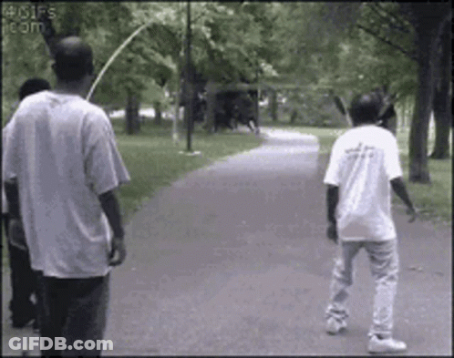 Man In White Shirt With Letter A Walking Down Path GIF