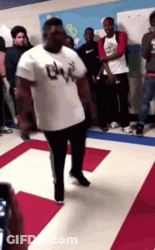 Man In White Shirt With Letter B Dancing In Crowd GIF