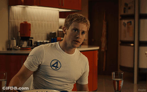 Man In White Shirt With Number 4 Sitting At Table GIF