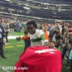 Man In White Shirt With Red Shirt On Back In Field GIF