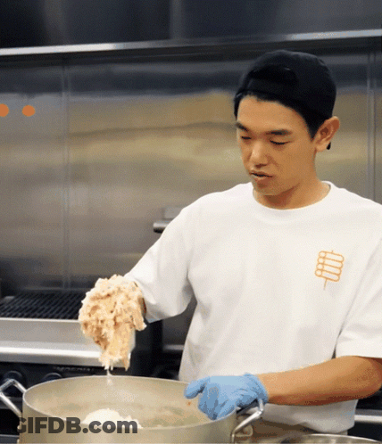 Man In White Shirt With Stick Cooking GIF