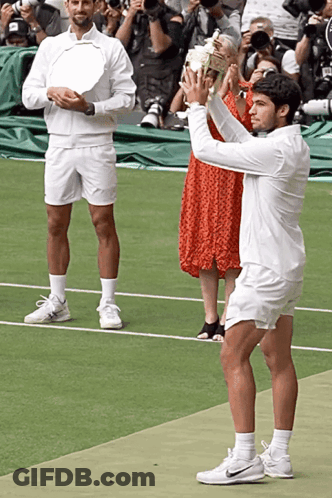 Man In White Shorts Holding Trophy GIF