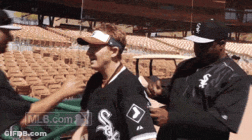 Man In White Sox Shirt Being Helped GIF