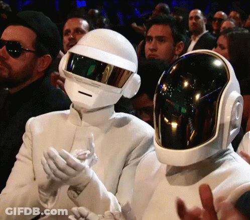 Man In White Suit And Helmet Next To Another Man In Helmet GIF