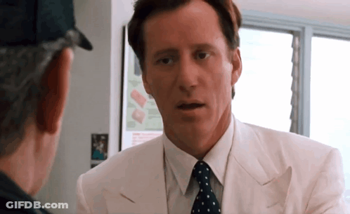 Man In White Suit And Polka Dot Tie Talking GIF