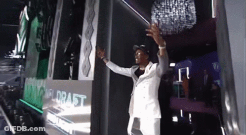 Man In White Suit At Draft Wall GIF