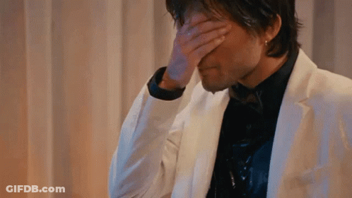 Man In White Suit Covering Face GIF