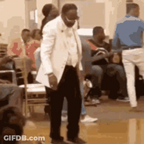 Man In White Suit Dancing In Front Of Crowd GIF