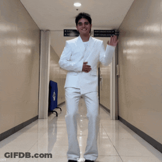 Man In White Suit Dancing In Hallway With GF Sign GIF